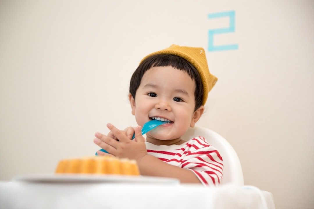 A young child brushing their teeth