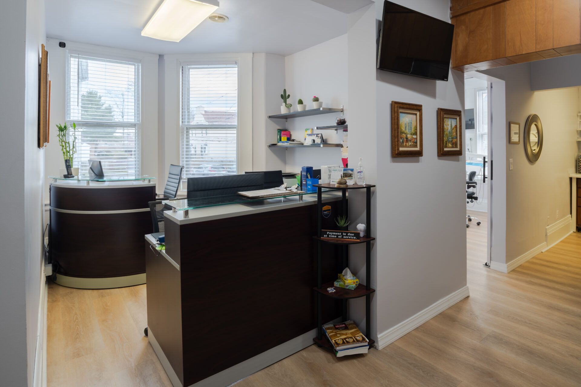Extended view of the reception desk area at Excellence Dental Care