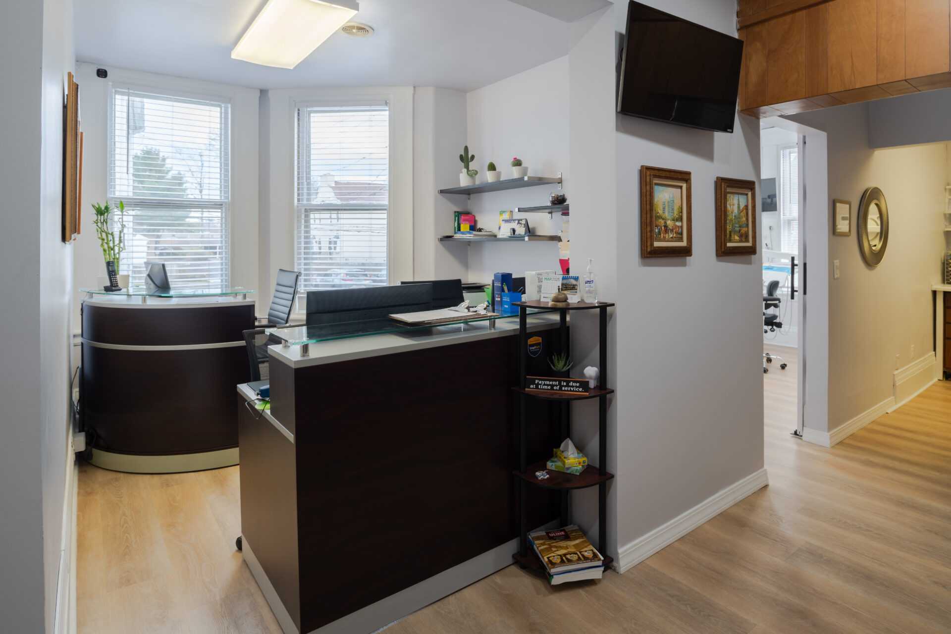 Extended view of the reception desk area at Excellence Dental Care