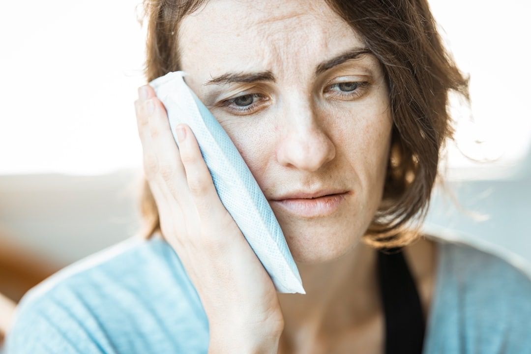 A dentist providing urgent care to a patient