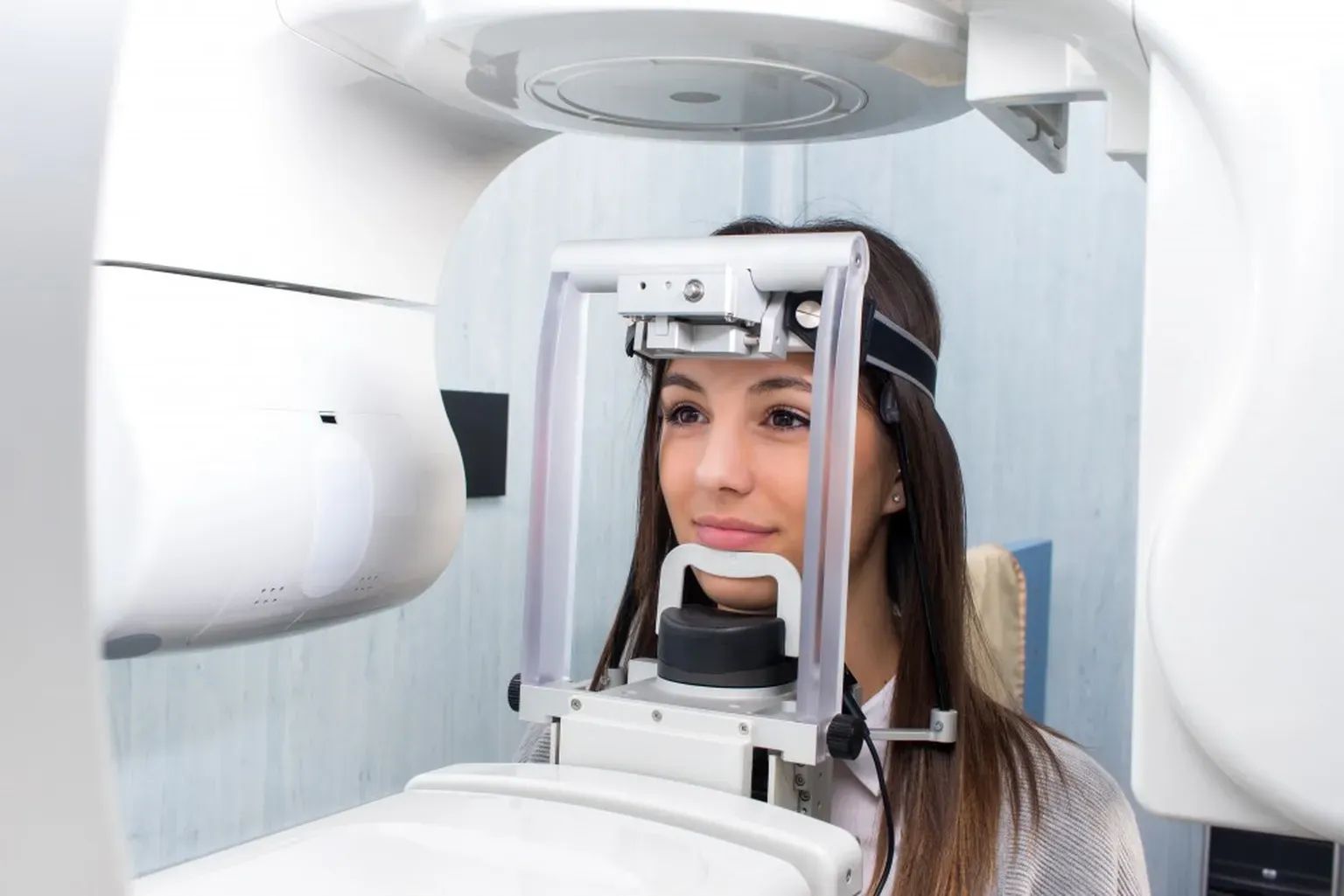 A patient positioned in a panoramic dental imaging machine