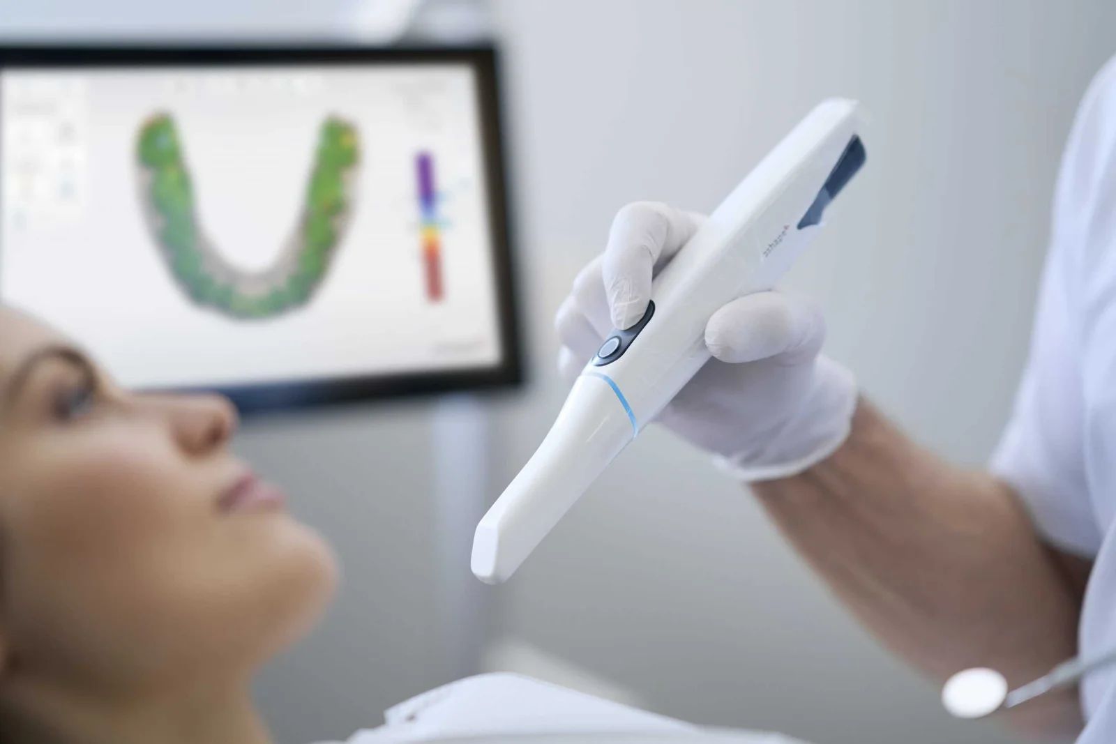 A dental professional using a TRIOS 5 intraoral scanner